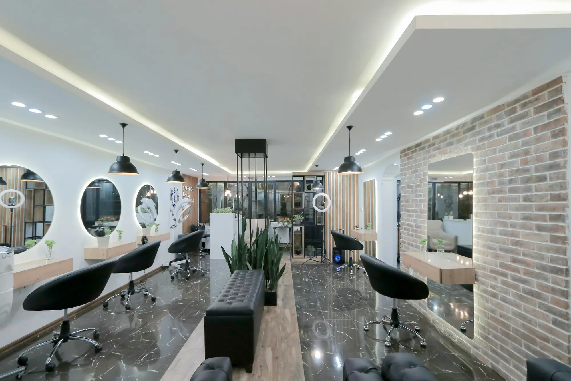 A modern hair salon with styling chairs and round mirrors
